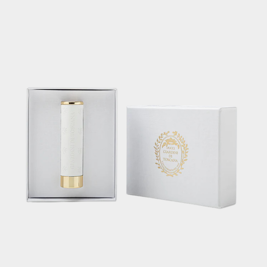 White and gold fragrance atomiser in a branded box on a light gray background